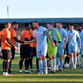 Rugby Town, led by captain Loyiso Recci, shake hands with local rivals Lutterworth Town before they went on to claim a fine 5-2 win over them in the Boxing Day derby at Butlin Road. Pictures by Martin Pulley