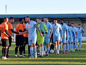 Rugby Town, led by captain Loyiso Recci, shake hands with local rivals Lutterworth Town before they went on to claim a fine 5-2 win over them in the Boxing Day derby at Butlin Road. Pictures by Martin Pulley