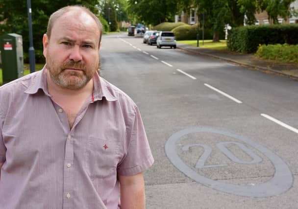 Warwickshire county councilor Will Roberts (Green Leamington Willes) shows one of the covered up 20mph speed markings in and around Gainsborough Drive in Sydenham. Picture supplied.