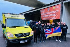 Volunteers deliver an ambulance on a previous trip. Picture supplied.