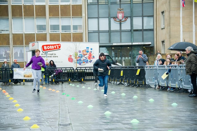 Warwick town centre, played host to the annual 'Pancake Race' this week.  Photo shows the adults' races.  Photo by Mike Baker