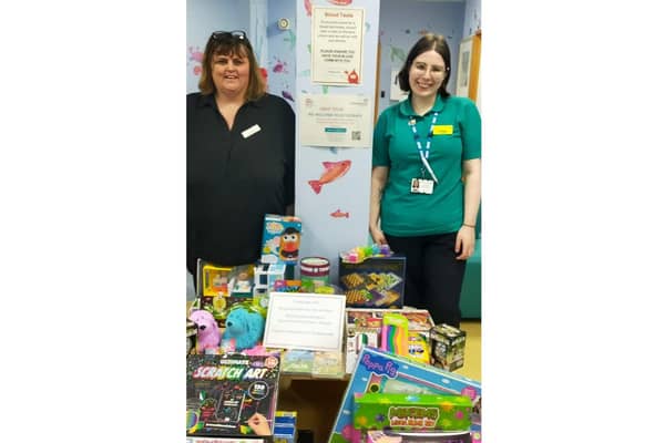 Rachel Devey (left), events manager at Leycester House care home, and her team recently met with Freya Asker (right), the play assistant on the ward this week to donate the gifts. Photo supplied