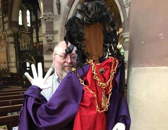 Thomas Wynter peeping mysteriously from behind a pillar, assisted by Alun Reed.