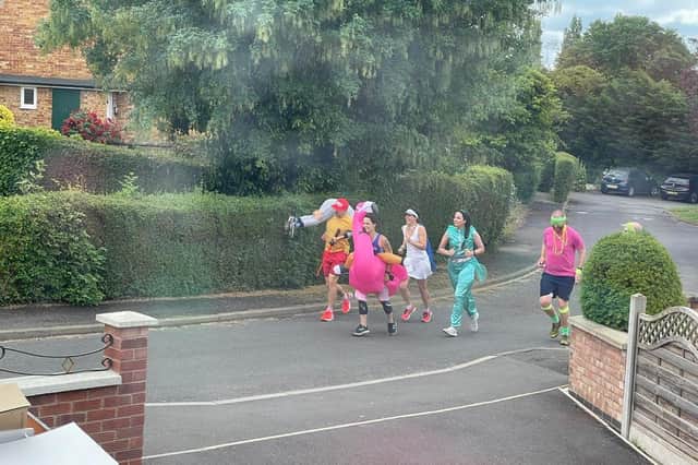 Sophie Knee-Higgins and her team of runners ran through Kineton dressed as an inflatable flamingo, Forest Gump, Princess Jasmine and Mr Motivator.