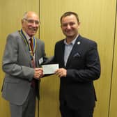 Warwick Rotary Club President Keith Talbot presenting Dawid Kozlowski from Leamington Polish Centre with a donation from the club. Photo supplied