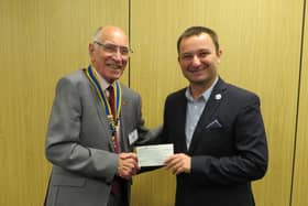 Warwick Rotary Club President Keith Talbot presenting Dawid Kozlowski from Leamington Polish Centre with a donation from the club. Photo supplied