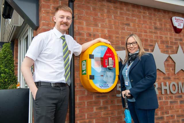 BN - SGB-32840 - Jack of Barratt Homes with Naomi from OurJay Foundation with the defibrillator