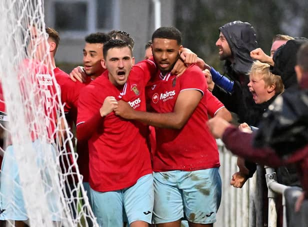 Provider Dan Summerfield and scorer Jordan Wilson celebrate Rugby Town's winner in the 3-2 success at Desborough Town. Picture by Martin Pulley