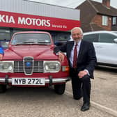 Barry Andrews (left) from Leamington Rotary Club with Kia Warwick managing director David Derbyshire and his classic 1975 Saab 95