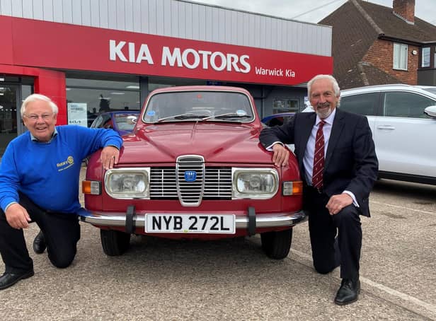 Barry Andrews (left) from Leamington Rotary Club with Kia Warwick managing director David Derbyshire and his classic 1975 Saab 95