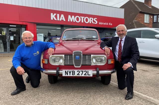 Barry Andrews (left) from Leamington Rotary Club with Kia Warwick managing director David Derbyshire and his classic 1975 Saab 95
