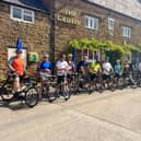 Riders wait for the start of the charity bike ride for Frank Wise School