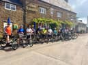 Riders wait for the start of the charity bike ride for Frank Wise School