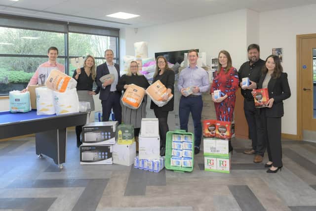 Staff at L&Q Estates with the donations raised during various fundraising events along with representatives from the charity. Photo supplied