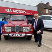 Barry Andrews (left) from Leamington Rotary Club with Kia Warwick managing director David Derbyshire and his classic 1975 Saab 95.