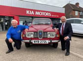 Barry Andrews (left) from Leamington Rotary Club with Kia Warwick managing director David Derbyshire and his classic 1975 Saab 95.