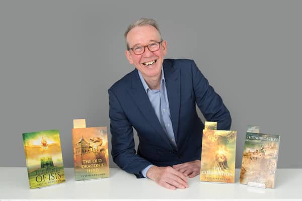Dr Justin Newland with his novels. Photo by Christopher Alan.