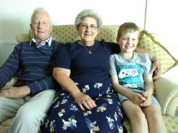 Colin Griffiths and Francoise Griffiths with one of their grandchildren, Thomas.