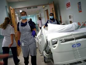 Medical staff transfer a patient along a corridor at the Royal Blackburn Teaching Hospital (Photo: HANNAH MCKAY/POOL/AFP via Getty Images)