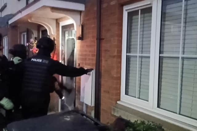 Warwickshire police officers raid a property as part of the County Lines Intensification Week. Credit:  Warwickshire Police.