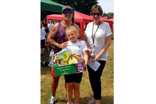 Justin Cole, Mrs Sutherland teacher at All Saint's School in Warwick and Orla accepting one of the three hampers given out to winning schools/nurseries. Photo supplied