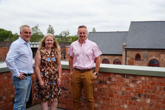 Councillor Jim Sinnott, Councillor Ella Billiald and James Brookes on the balcony of the Stoneleigh Arms, overlooking the Old School and the Court Street Creative Arches. Photo by Warwick District Council.