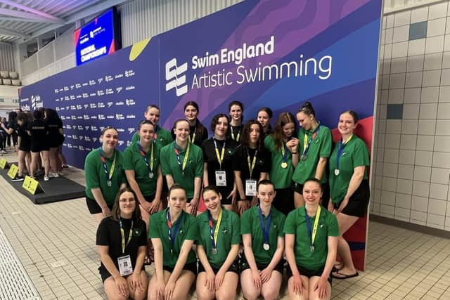Swimmers show off their wins.