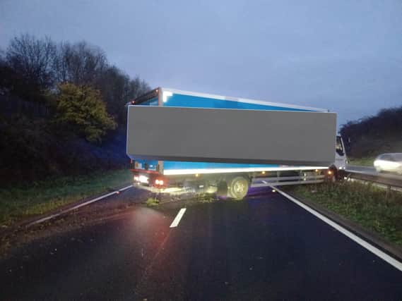 There are long traffic delays in the area after an HGV collided with the central reservation on the A46.