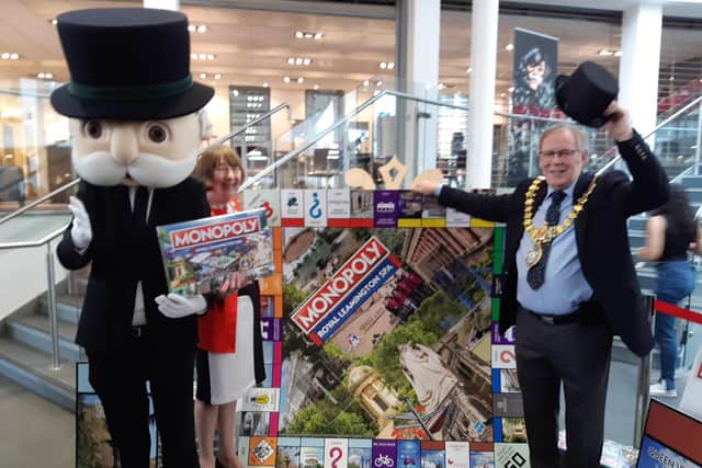 Warwick District Council Chair Cllr Sidney Syson and Leamington Mayor Cllr Alan Boad help Mr Monopoly to launch Monopoly: Royal Leamington Spa Edition at  Royal Leamington Spa College.