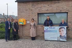 The defibrillator is now in place at St Gabriel's School. Pictured are: headteacher at St Gabriel’s School Andrew Taylor, Jamie's mum Naomi Issitt, Houlton's community development lead Sonia Nakra-Norman, Jamie's stepdad Jeremy Issitt and Jamie's nan, Karen.