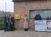 The defibrillator is now in place at St Gabriel's School. Pictured are: headteacher at St Gabriel’s School Andrew Taylor, Jamie's mum Naomi Issitt, Houlton's community development lead Sonia Nakra-Norman, Jamie's stepdad Jeremy Issitt and Jamie's nan, Karen.