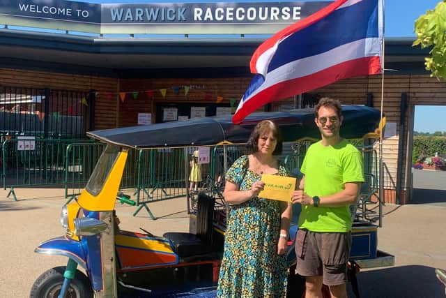 The raffle for a flight to Thailand was won by Vicki Morris, who is pictured receiving an Eva-Air voucher from Magic of Thailand’s Daniel Biggs. Photo supplied