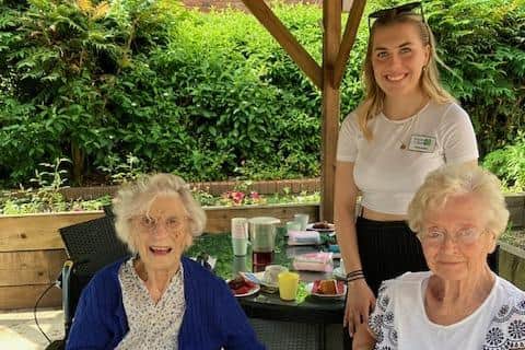 Grace Calder, KiB gap year volunteer with residents. Photo supplied