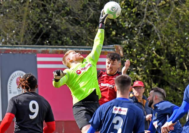Goalkeeper Ash Bodycote rises above the mix to secure the ball for Rugby against Rothwell Corinthians  Picture by Martin Pulley