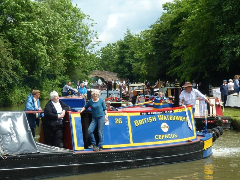 Former working boatwoman Alice Lapworth is seen onboard of the former GUCCC Star Class motor Cepheus coming out of Braunston Marina to join the 2015 boat parade.