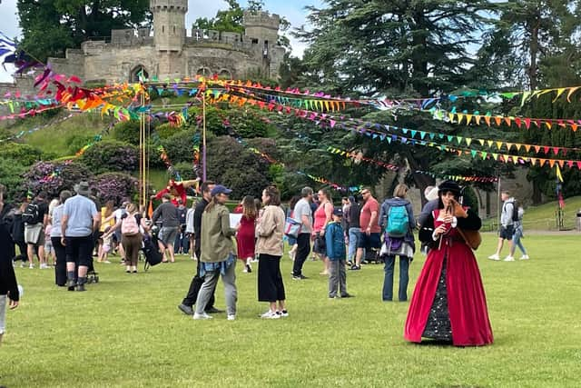 The courtyard gathering with minstrels and a jester. Photo by Kirstie Smith