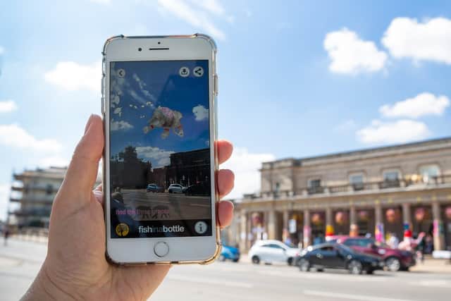 Wilhelmina the elephant flies over the Pump Rooms thanks to Fish in a Bottle's augmented reality app, specially written for Art in the Park 2018. Photo by Linda Scannell.