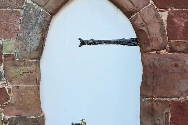 A 14th century wooden door at historic Peter Hall had a hole cut into it so a garden tap could be installed.