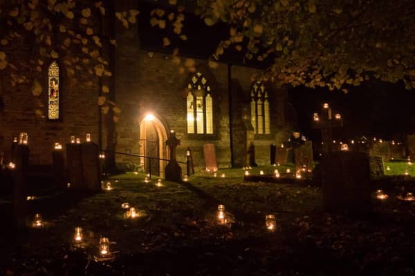 Hundreds of candles adorn the churchyard for Night of Our Light.