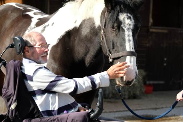 Rotarian Andrew Morley from the Warwick Avon Rotary  Club with George the horse at RDA in Shrewley. Picture supplied.