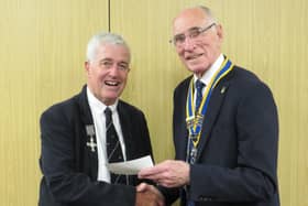 Warwick Rotary Club President Keith Talbot (right) with Alistair Price wearing his father’s medals (left). Photo supplied