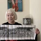 Orbit resident Olivia Ogilvie-Stewart holding a newspaper clipping of her at the Warwickshire Coronation Pageant in 1953.