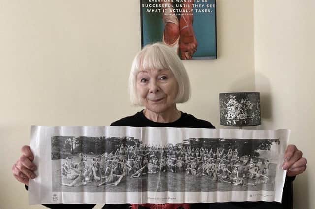 Orbit resident Olivia Ogilvie-Stewart holding a newspaper clipping of her at the Warwickshire Coronation Pageant in 1953.