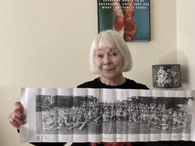Orbit resident Olivia Ogilvie-Stewart holding a newspaper clipping of her at the Warwickshire Coronation Pageant in 1953.