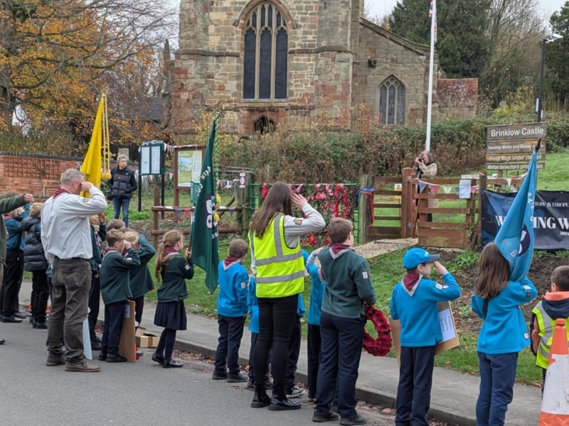 Beavers/Cubs and Scouts salutie the Walking with Heroes Statues at Remembrance Sunday in Brinklow.