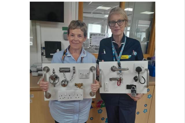 Staff members on the Victoria Ward with the fiddle boards. Photo supplied