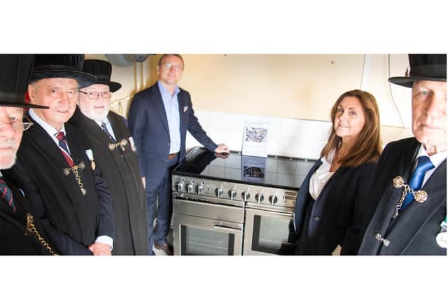 Lord Leycester Brethren, Iskender Diker, commercial director at Middleby Residential (Rangemaster) and Kathryn Lowe, marketing manager at AGA Rangemaster with the new cooker. Photo by Gill Fletcher