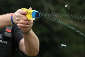 File photo 26/02/13 of a police officer demonstrating the use of a Taser as a majority of the public think it is acceptable for police to carry Tasers when on patrol, a survey suggests.
