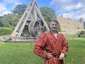 Warwick Castle's Guy de Beauchamp, the 10th Earl of Warwick, near the trebuchet. Photo by Warwick Castle