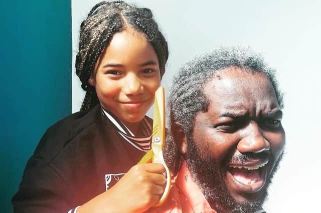 Lexy Botsoe, 10, and her dad Peter, who has agreed for her to cut off his braids as part of her campaign to raise  money to add  more diverse books to the reading list at Park Hill Junior School in Kenilworth.